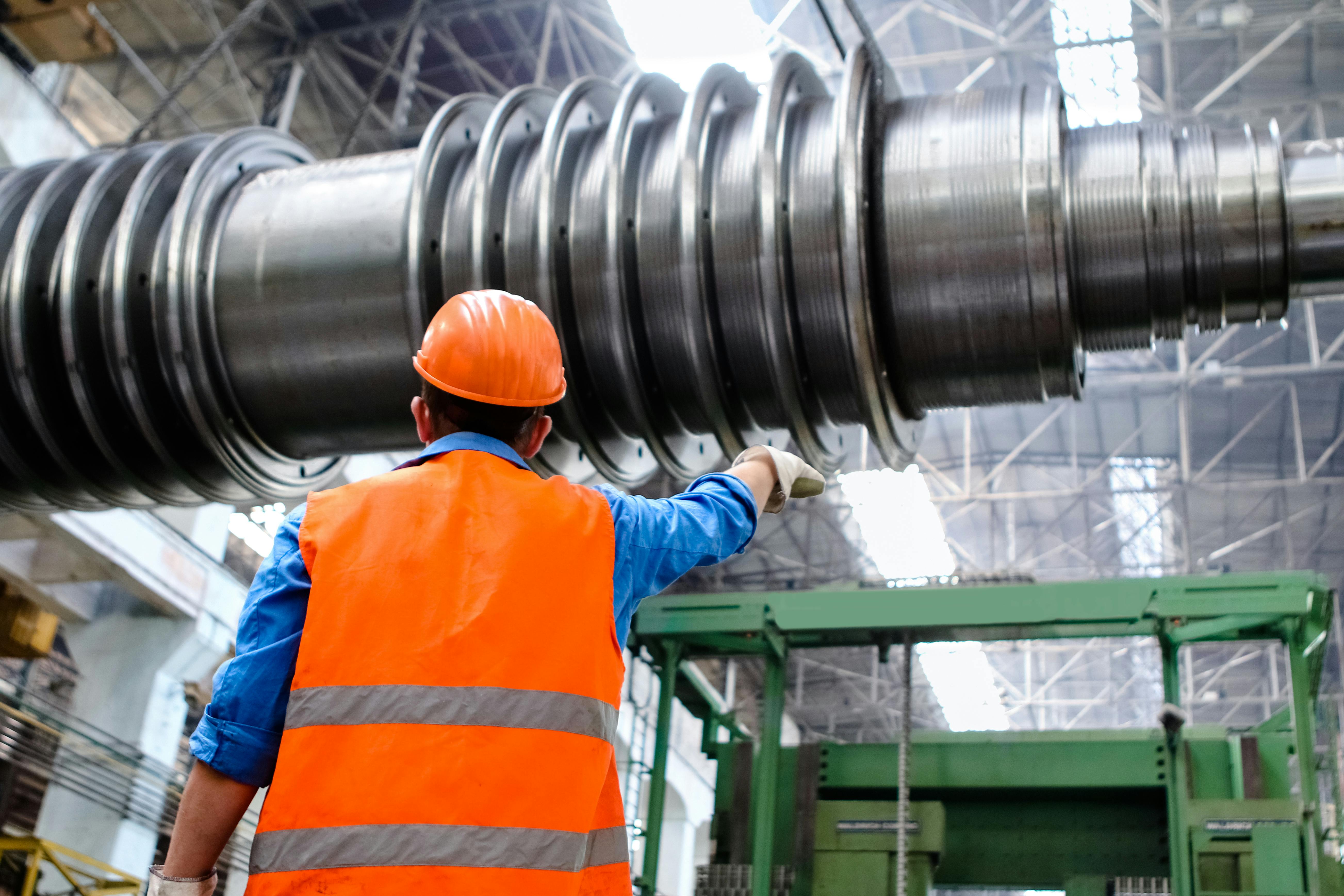 Maintenance worker performing lockout tagout procedures on heavy industrial equipment