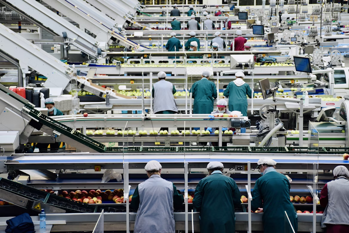 Food and beverage processing facility workers on production line — LOTO compliance for food manufacturing